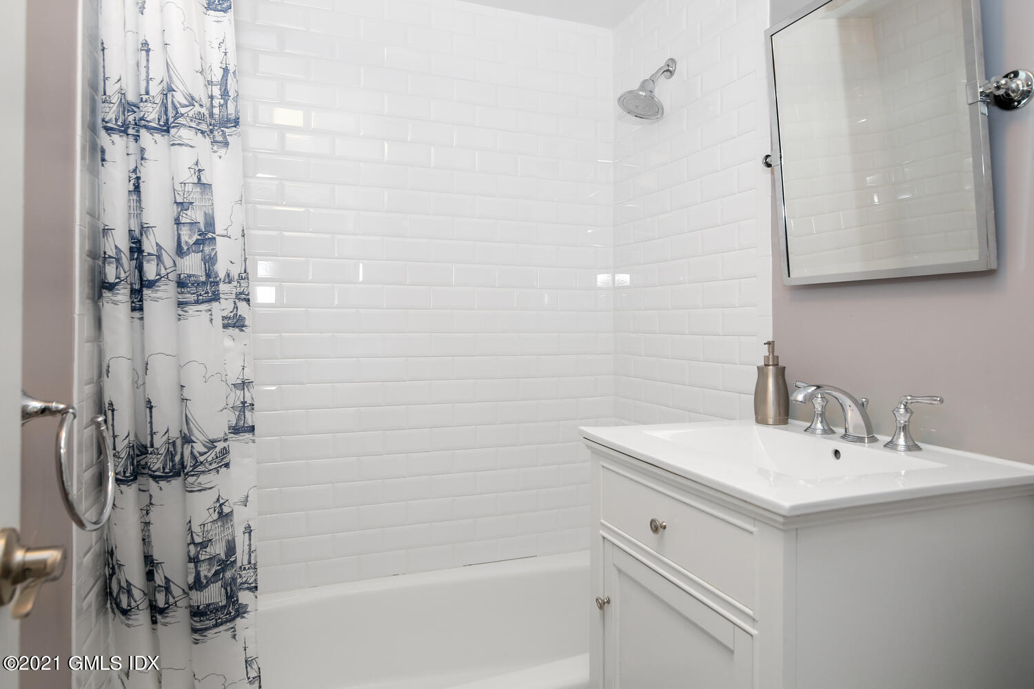 65 Summit Road Riverside, CT 06878 - Photo 12 of 20 a bathroom with a sink mirror and shower