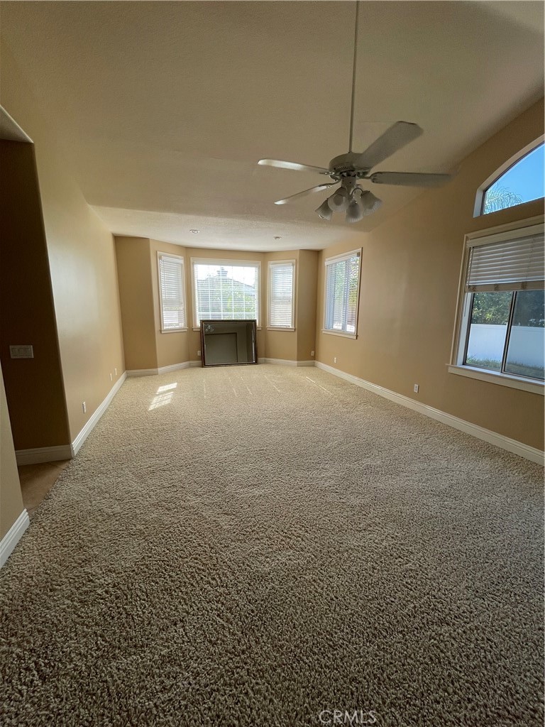 1 Vía Perico Rancho Santa Margarita, CA 92688 - Photo 14 of 22 an empty room with windows and ceiling fan