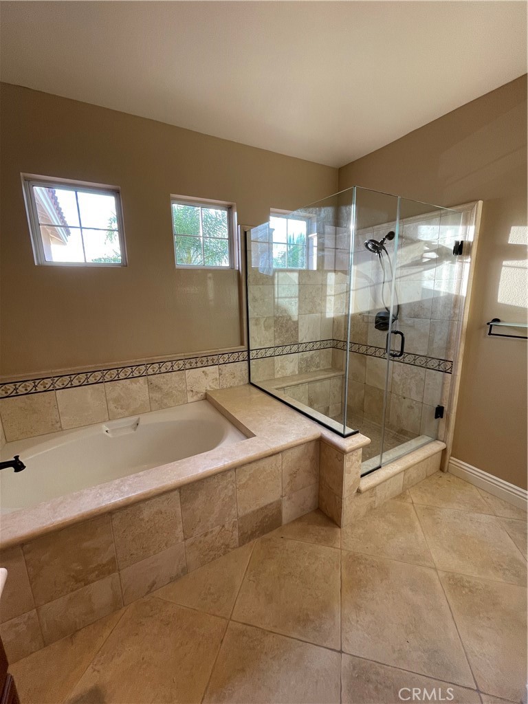 1 Vía Perico Rancho Santa Margarita, CA 92688 - Photo 16 of 22 a spacious bathroom with a granite countertop bathtub next to a window