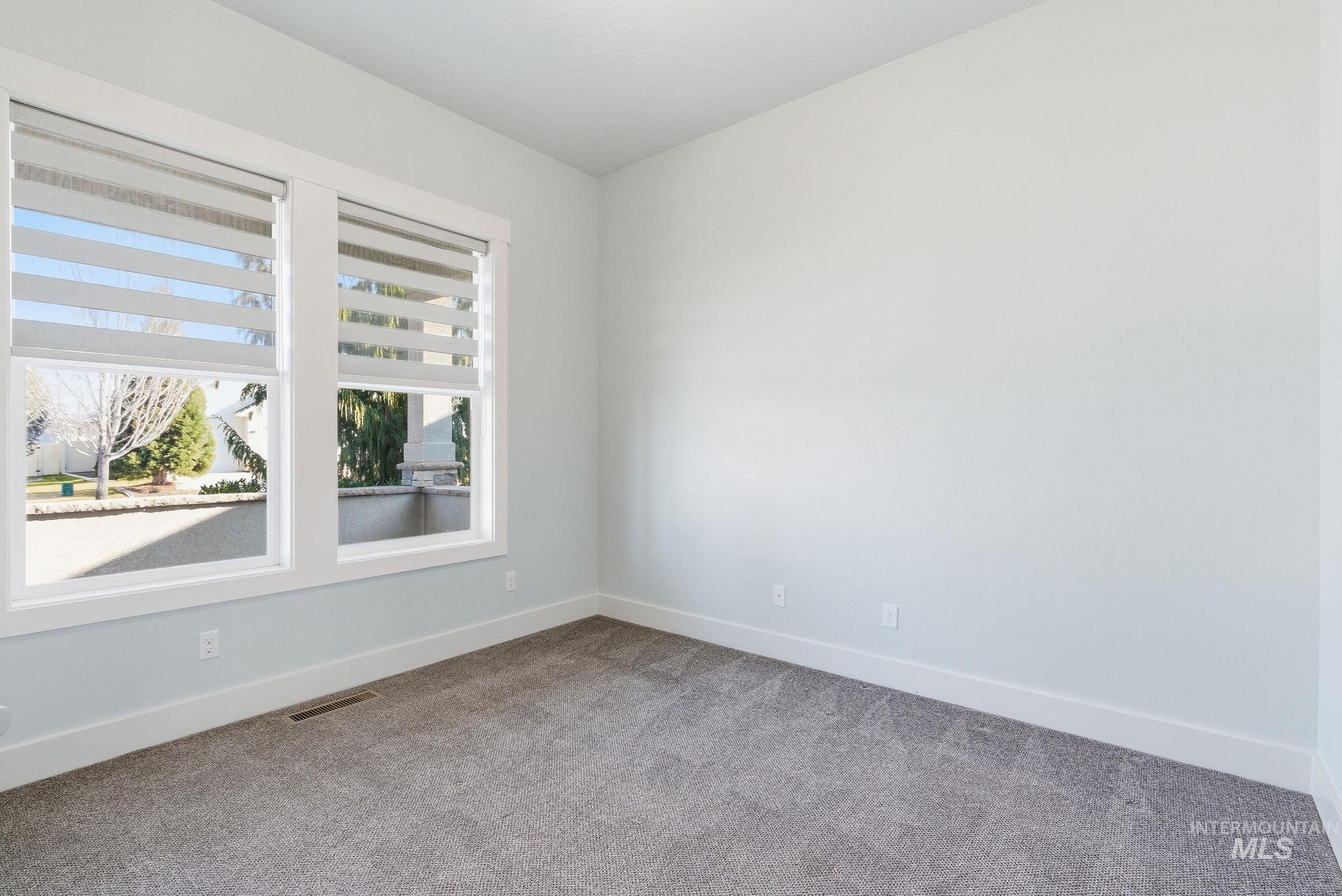 1013 East Radiant Ridge Drive Meridian, ID 83642 - Photo 16 of 36 Spare room featuring baseboards and carpet flooring