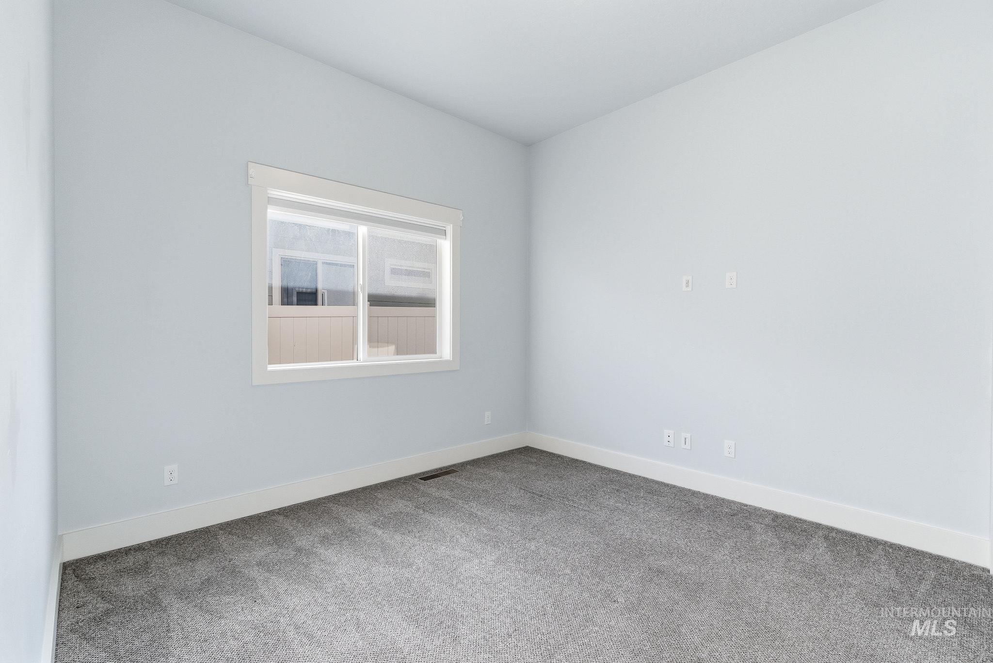 1013 East Radiant Ridge Drive Meridian, ID 83642 - Photo 19 of 36 Empty room with carpet flooring and baseboards