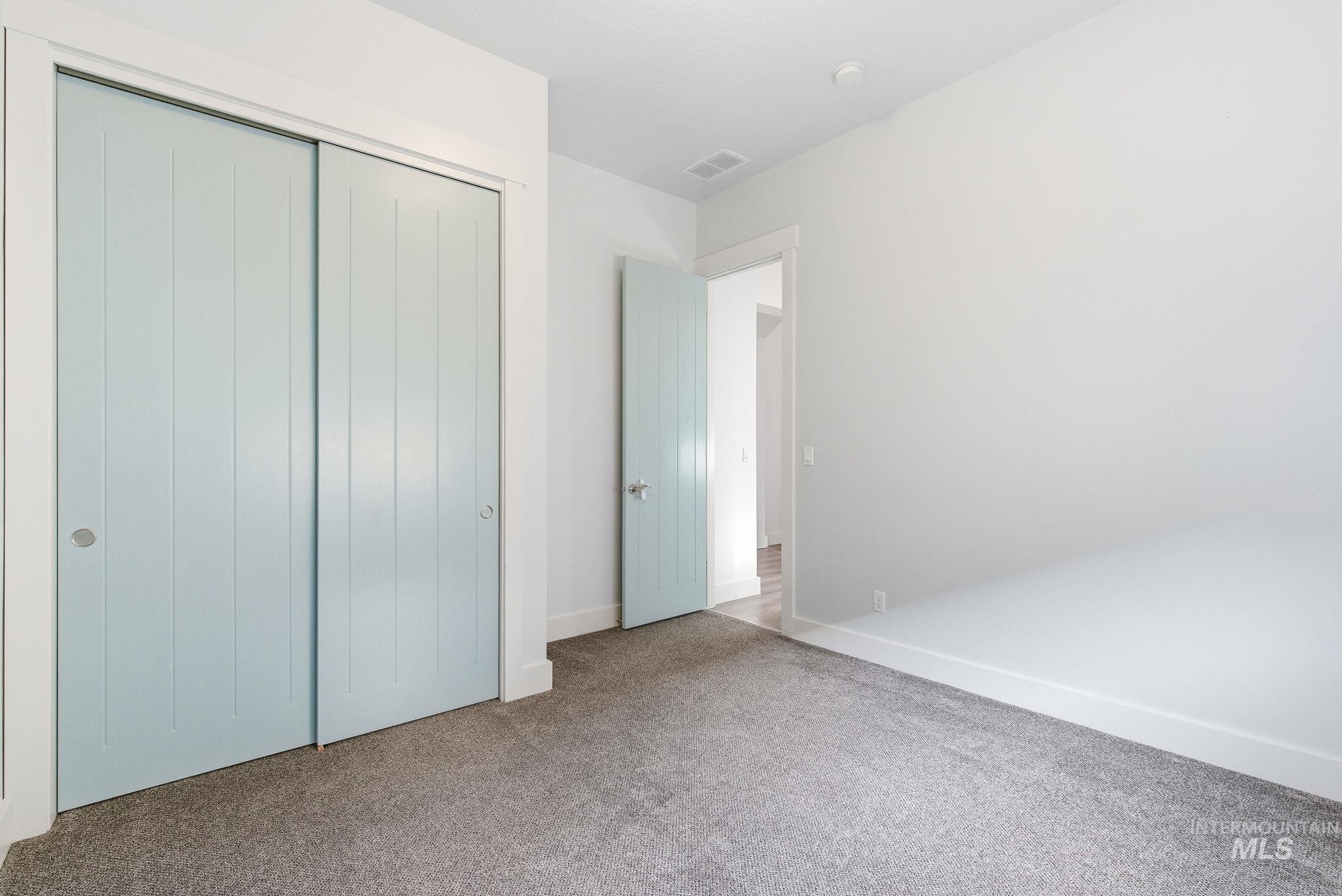 1013 East Radiant Ridge Drive Meridian, ID 83642 - Photo 20 of 36 Unfurnished bedroom with a closet and carpet floors