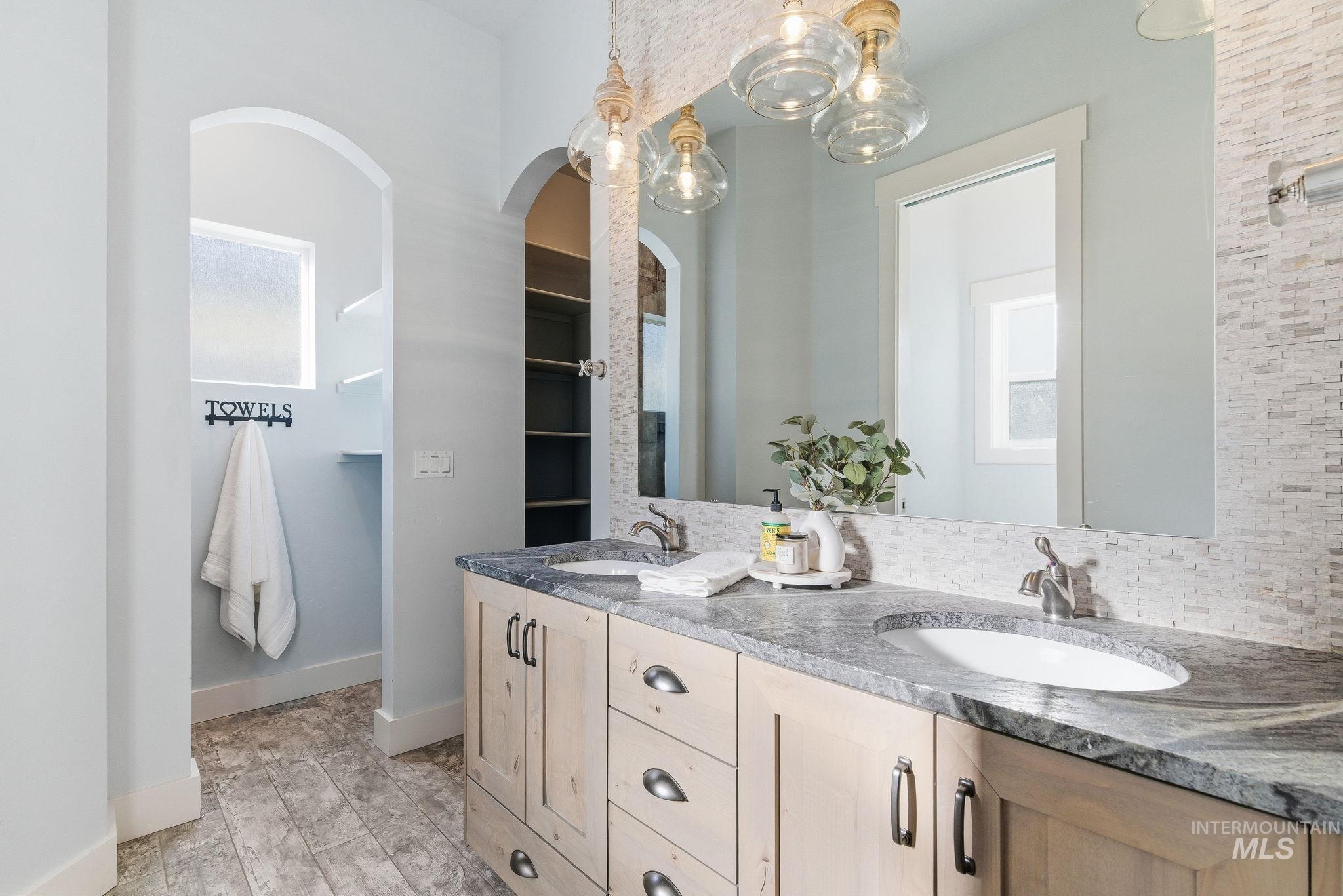 1013 East Radiant Ridge Drive Meridian, ID 83642 - Photo 24 of 36 Full bathroom with double vanity and tasteful backsplash