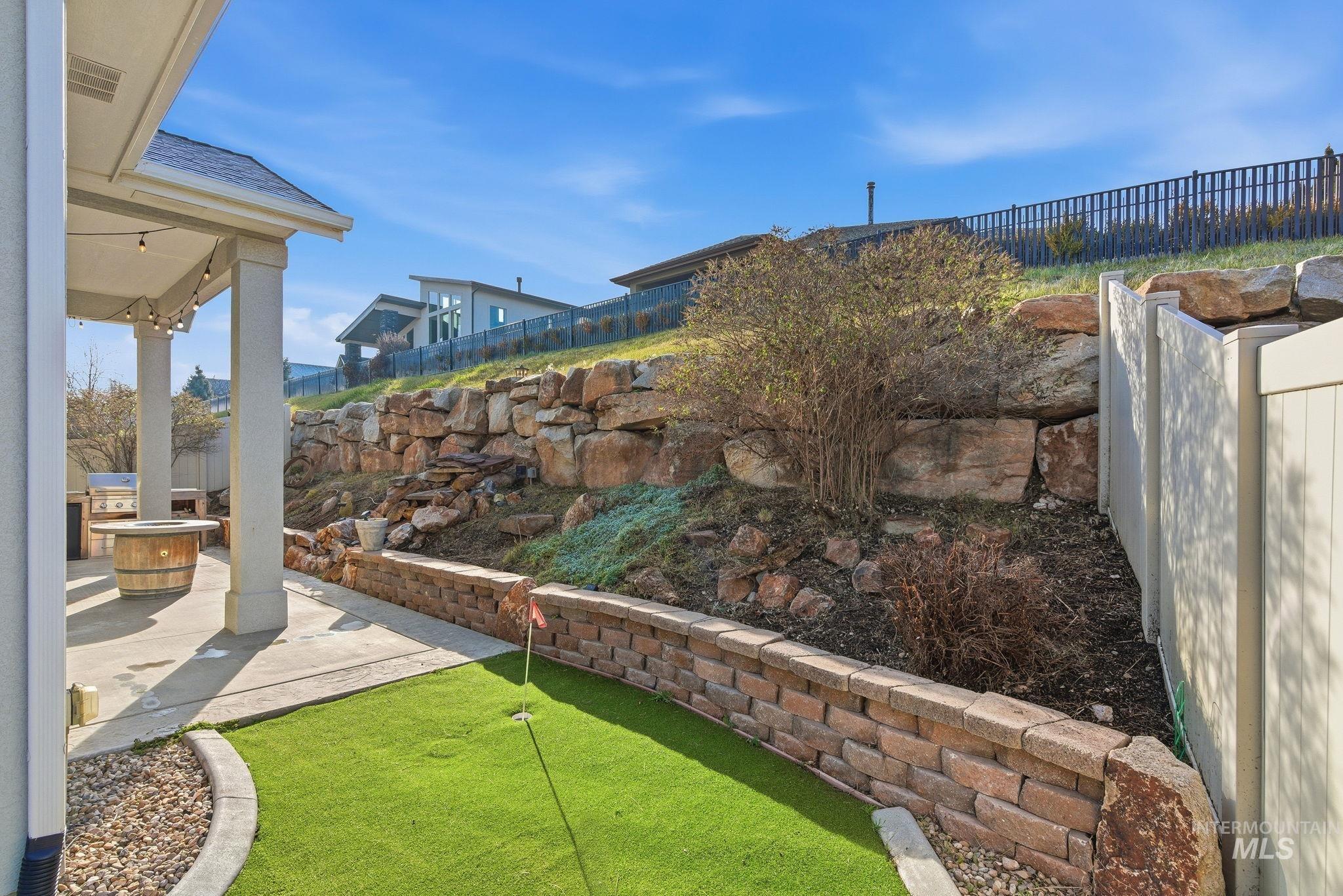 1013 East Radiant Ridge Drive Meridian, ID 83642 - Photo 36 of 36 Fenced backyard featuring a putting green and a patio