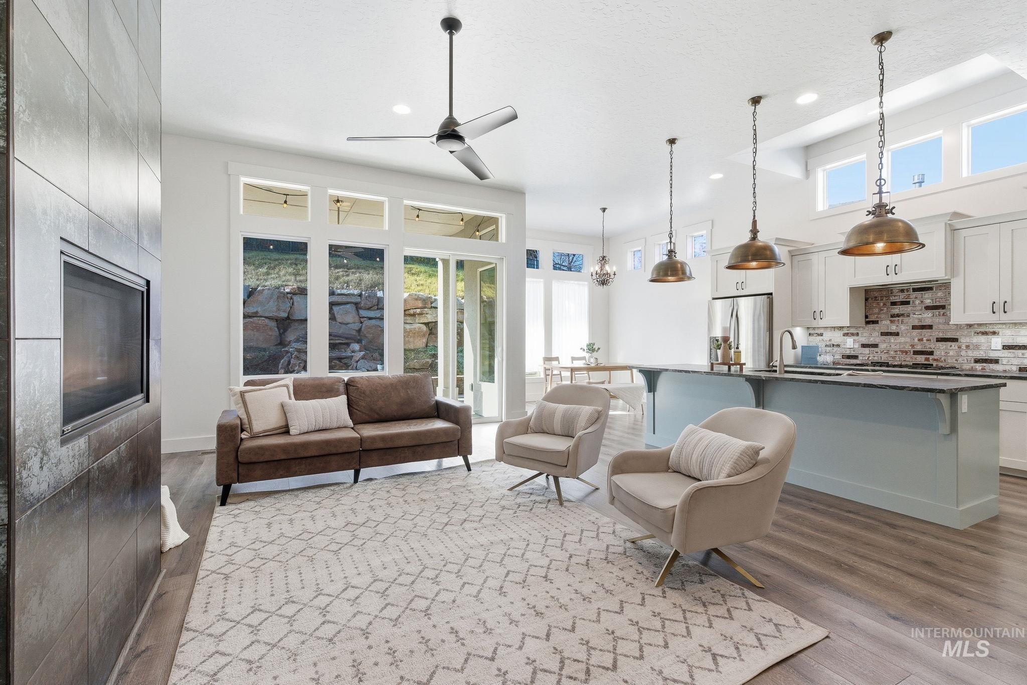 1013 East Radiant Ridge Drive Meridian, ID 83642 - Photo 5 of 36 Living area with light wood-style flooring, ceiling fan, recessed lighting, and a high ceiling