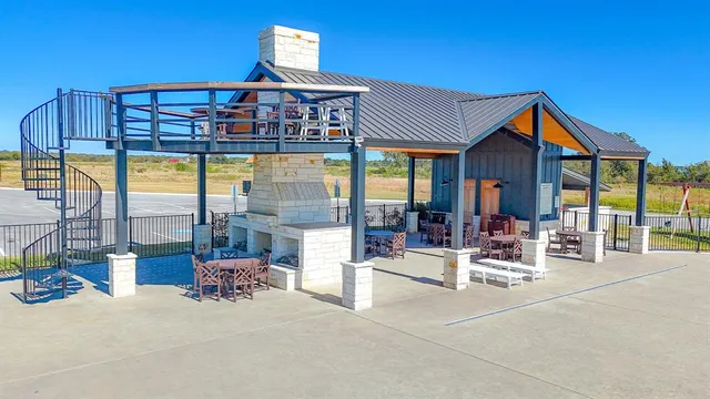 a view of a patio with a table & chairs