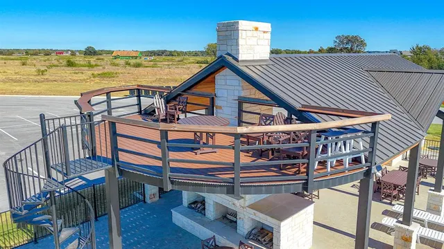 a view of a roof deck with chair and wooden floor