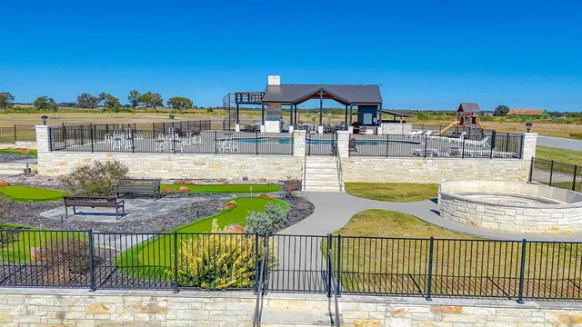 a view of a swimming pool with outdoor seating space