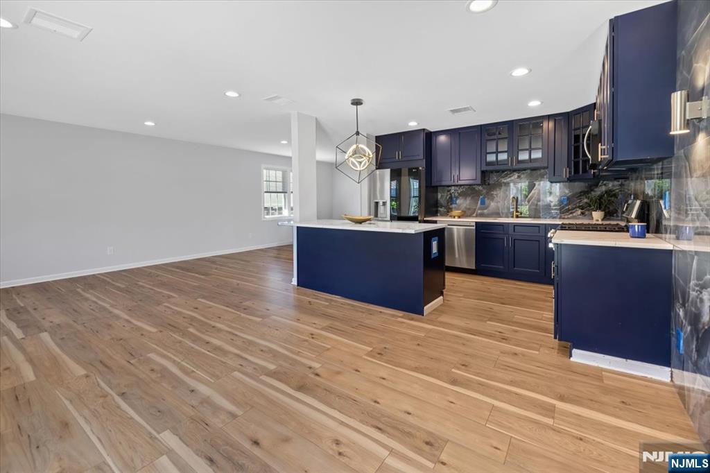 77 B Chestnut Street Lodi, NJ 07644 - Photo 11 of 36 a large kitchen with stainless steel appliances granite countertop a stove and a wooden floors
