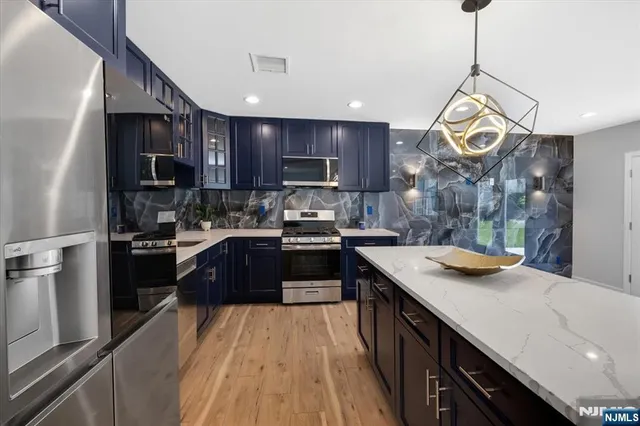 a kitchen with a sink stove and refrigerator