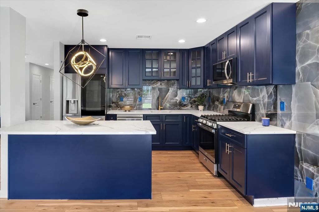 77 B Chestnut Street Lodi, NJ 07644 - Photo 14 of 36 a kitchen with granite countertop stainless steel appliances and wooden cabinets