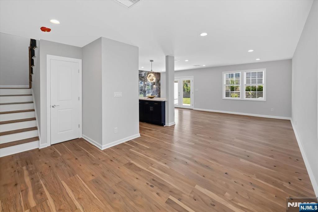 77 B Chestnut Street Lodi, NJ 07644 - Photo 15 of 36 an empty room with wooden floor and windows