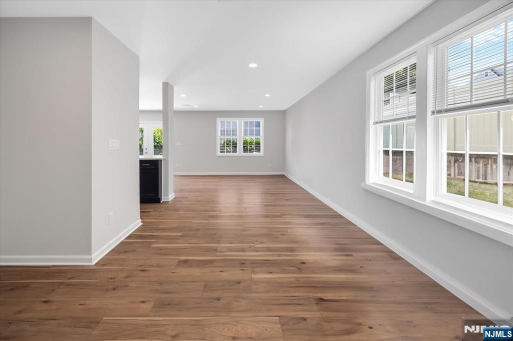 77 B Chestnut Street Lodi, NJ 07644 - Photo 16 of 36 a view of an empty room with wooden floor and a window