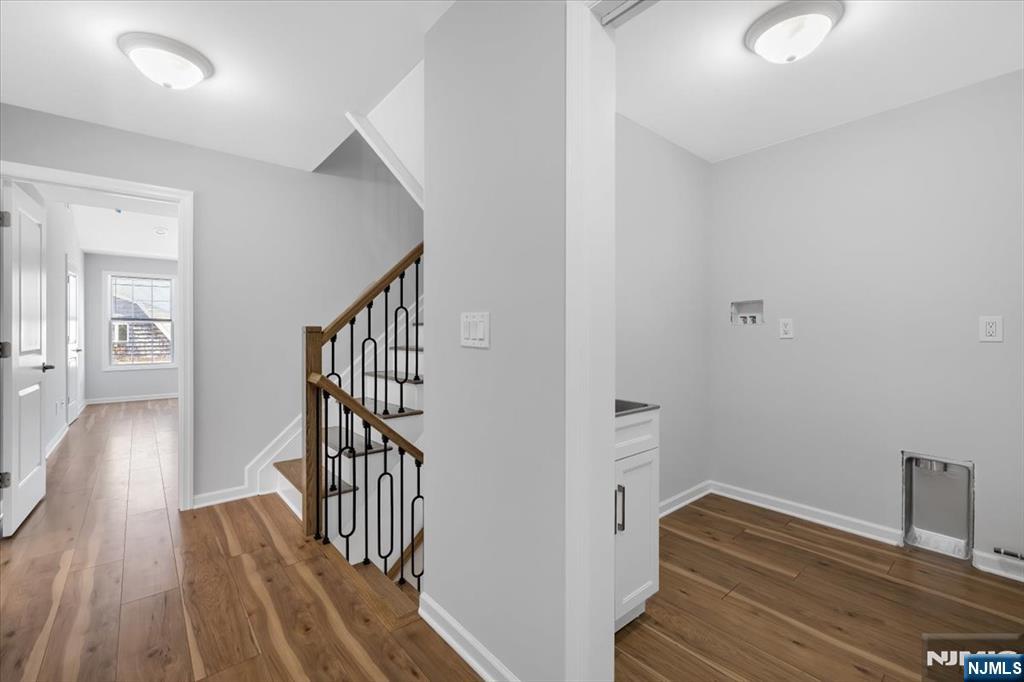 77 B Chestnut Street Lodi, NJ 07644 - Photo 19 of 36 a view of a hallway with wooden floor and stairs
