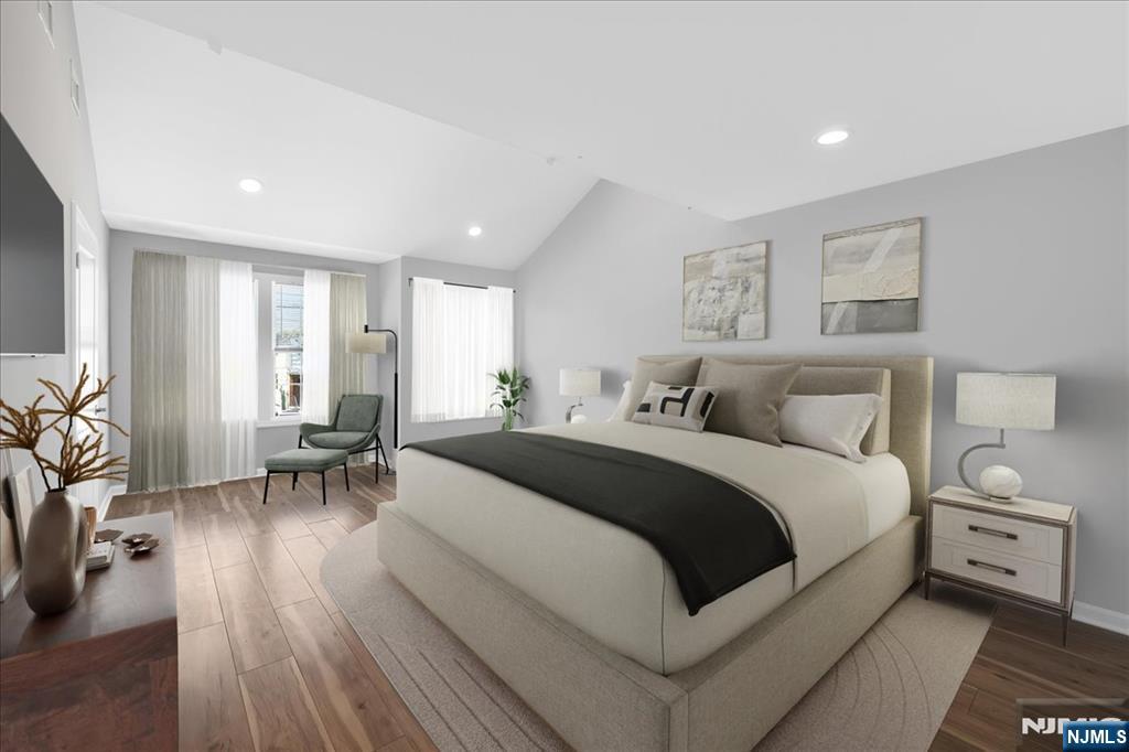 77 B Chestnut Street Lodi, NJ 07644 - Photo 20 of 36 a bed room with a bed and a chair