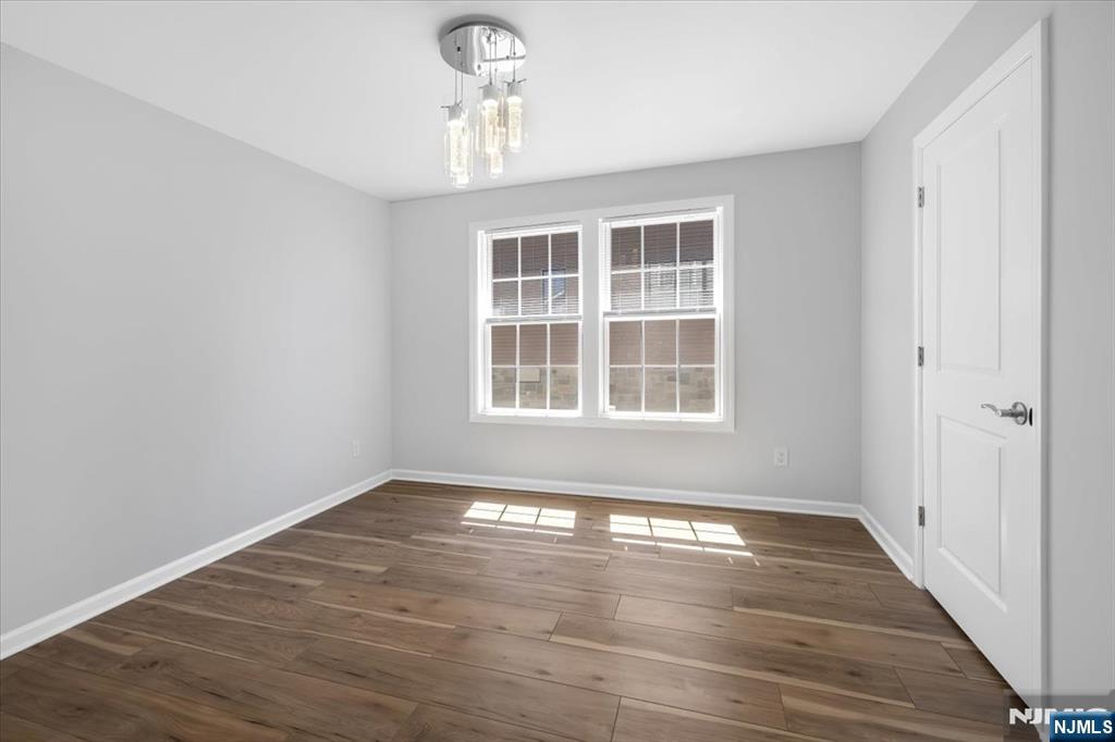 77 B Chestnut Street Lodi, NJ 07644 - Photo 34 of 36 a view of empty room with wooden floor and fan