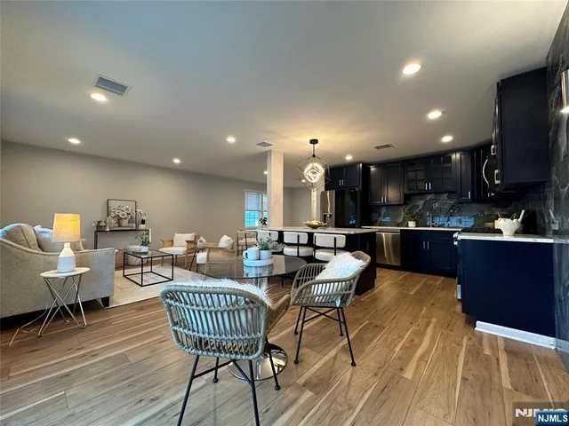 a living room with dining room and kitchen view
