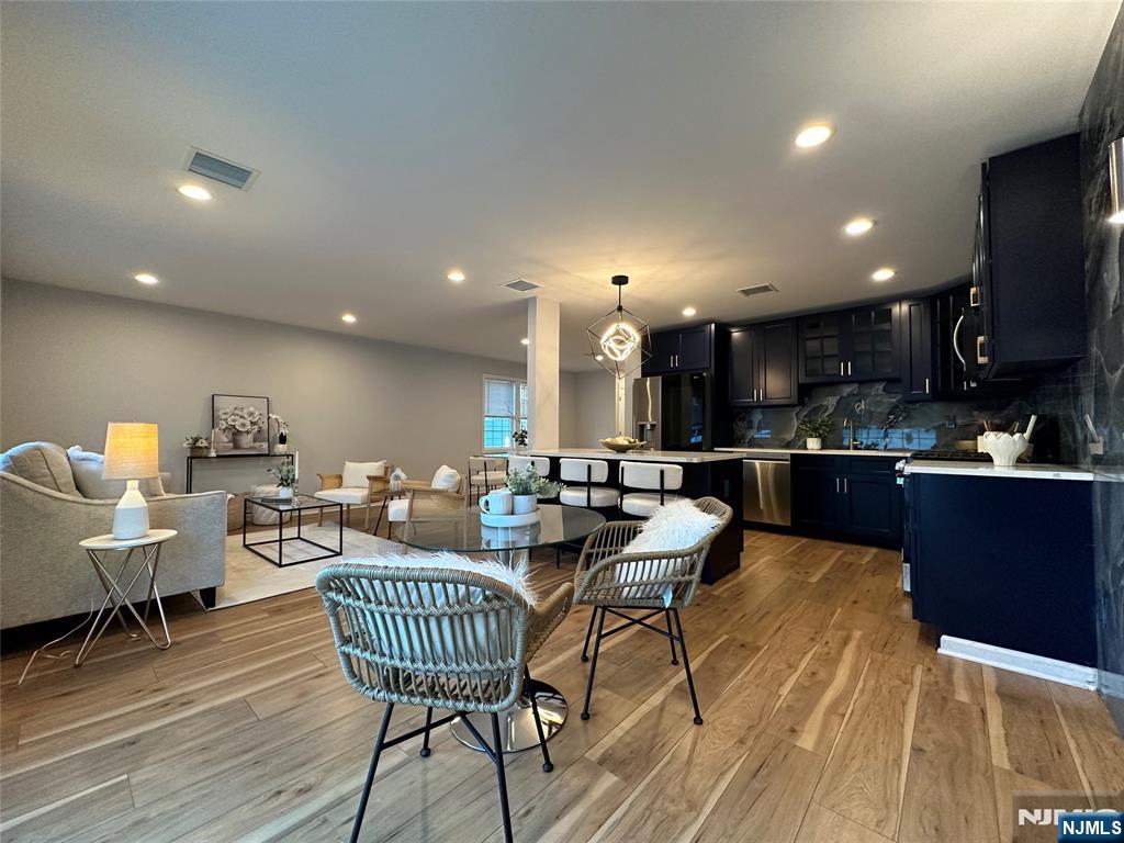 77 B Chestnut Street Lodi, NJ 07644 - Photo 4 of 36 a living room with dining room and kitchen view