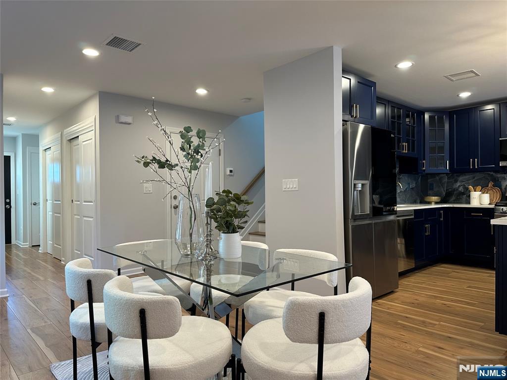 77 B Chestnut Street Lodi, NJ 07644 - Photo 7 of 36 a kitchen with a refrigerator and wooden floor
