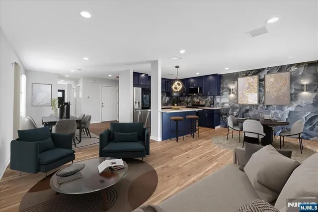 a living room with furniture and a view of kitchen