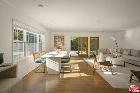 a living room with fireplace furniture and a large window