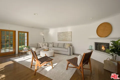a living room with furniture and a mirror
