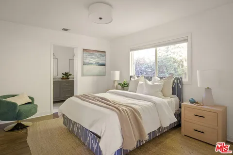 a spacious bedroom with a bed and a couch