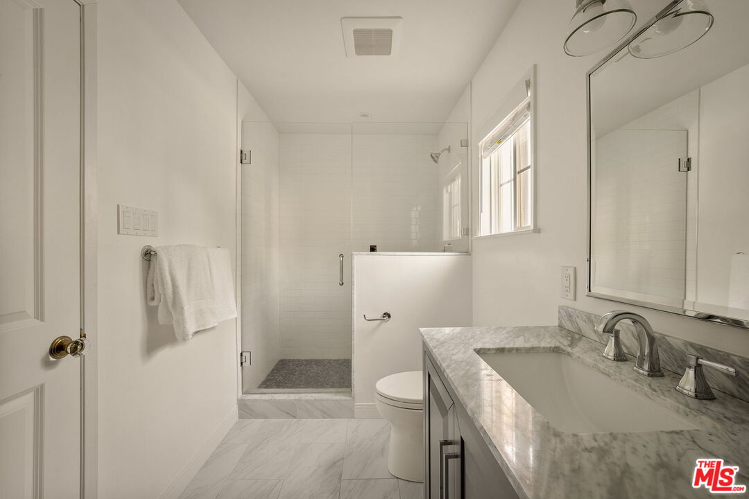 1209 Appleton Way Venice, CA 90291 - Photo 30 of 46 a bathroom with a granite countertop sink a toilet and shower