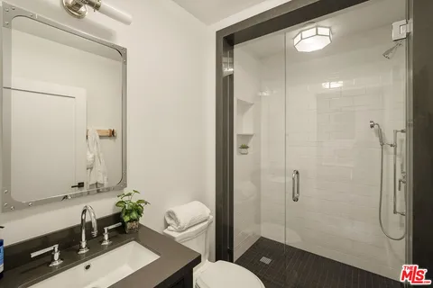 a bathroom with a shower and a toilet