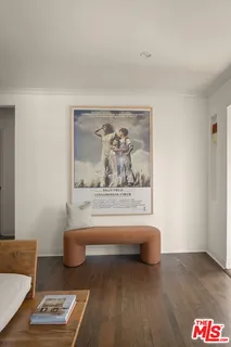 a view of a bedroom with furniture and wooden floor