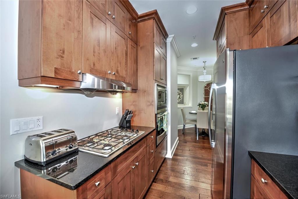 555 5th Avenue South, Unit PH1 Naples, FL 34102 - Photo 11 of 31 a kitchen with stainless steel appliances granite countertop a stove and a refrigerator