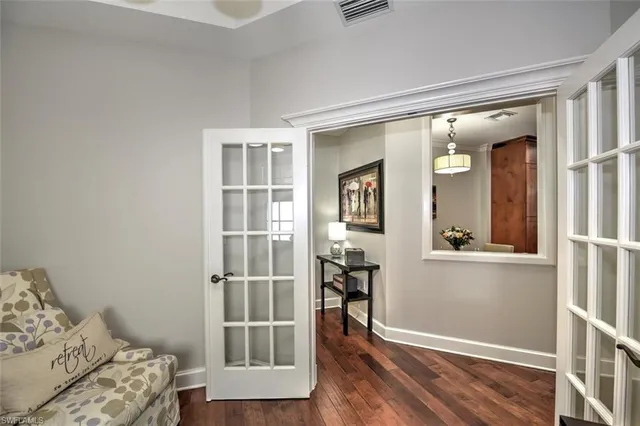 a view of a livingroom with wooden floor and a bedroom