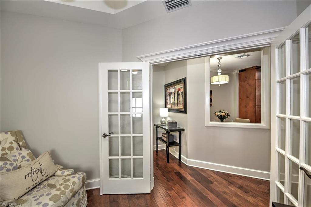 555 5th Avenue South, Unit PH1 Naples, FL 34102 - Photo 14 of 31 a view of a livingroom with wooden floor and a bedroom