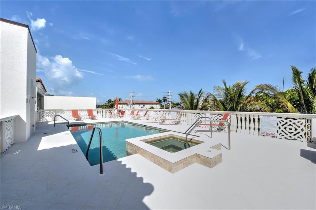 555 5th Avenue South, Unit PH1 Naples, FL 34102 - Photo 27 of 31 a view of a swimming pool with a patio and fire pit