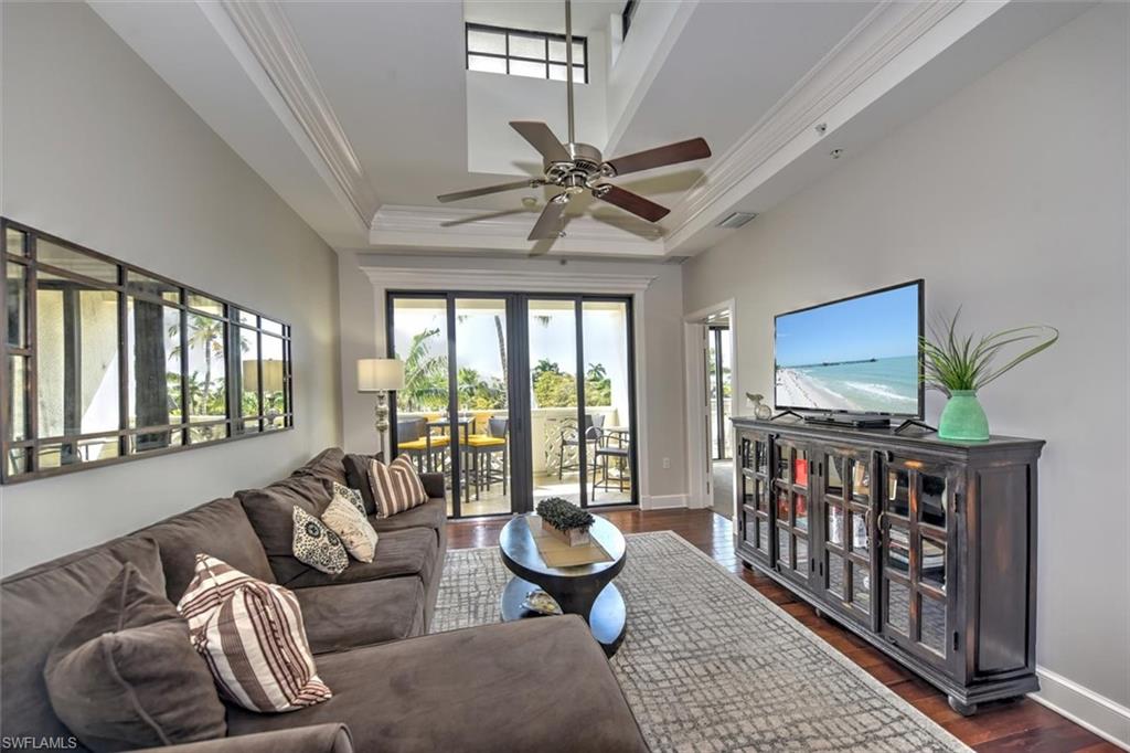 555 5th Avenue South, Unit PH1 Naples, FL 34102 - Photo 4 of 31 a living room with furniture and a flat screen tv