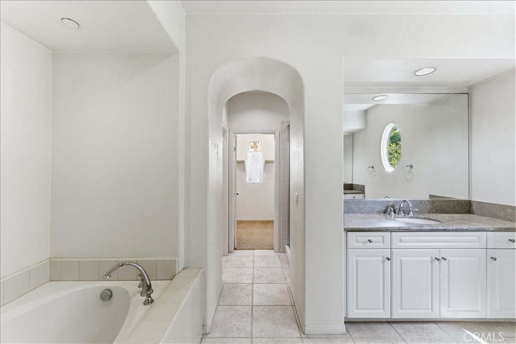480 Santa Maria Street Anaheim, CA 92801 - Photo 12 of 17 a spacious bathroom with a granite countertop sink a mirror and a bathtub