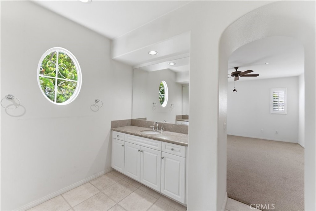 480 Santa Maria Street Anaheim, CA 92801 - Photo 13 of 17 a bathroom with a granite countertop sink a mirror and a vanity