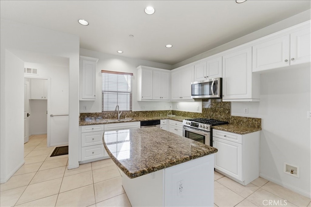 480 Santa Maria Street Anaheim, CA 92801 - Photo 2 of 17 a kitchen with kitchen island granite countertop a stove sink and microwave