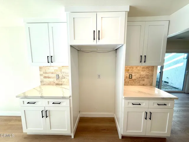 a kitchen with stainless steel appliances granite countertop a stove and a wooden floors