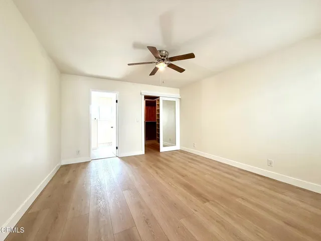 a view of walk in closet and empty room