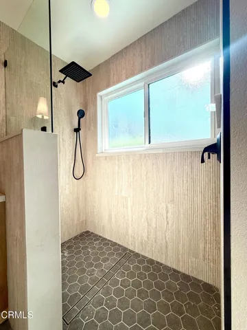 a bathroom with a double vanity sink mirror and shower