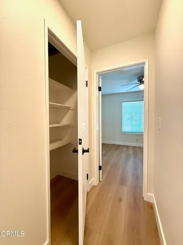 a view of a room with wooden floor