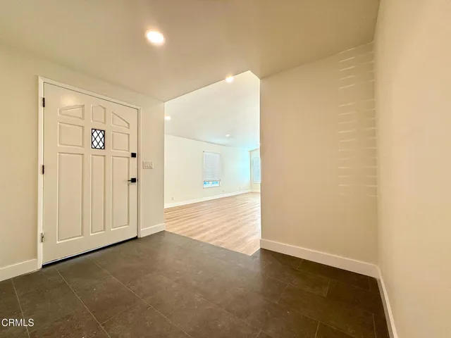 an empty room with wooden floor and fireplace
