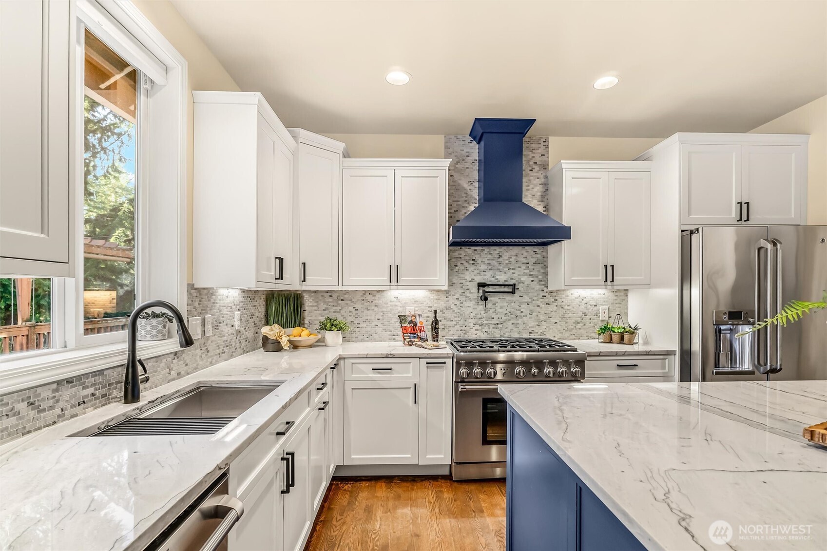 13718 58th Street Southeast Snohomish, WA 98290 - Photo 11 of 40 a kitchen with stainless steel appliances granite countertop a sink stove and refrigerator