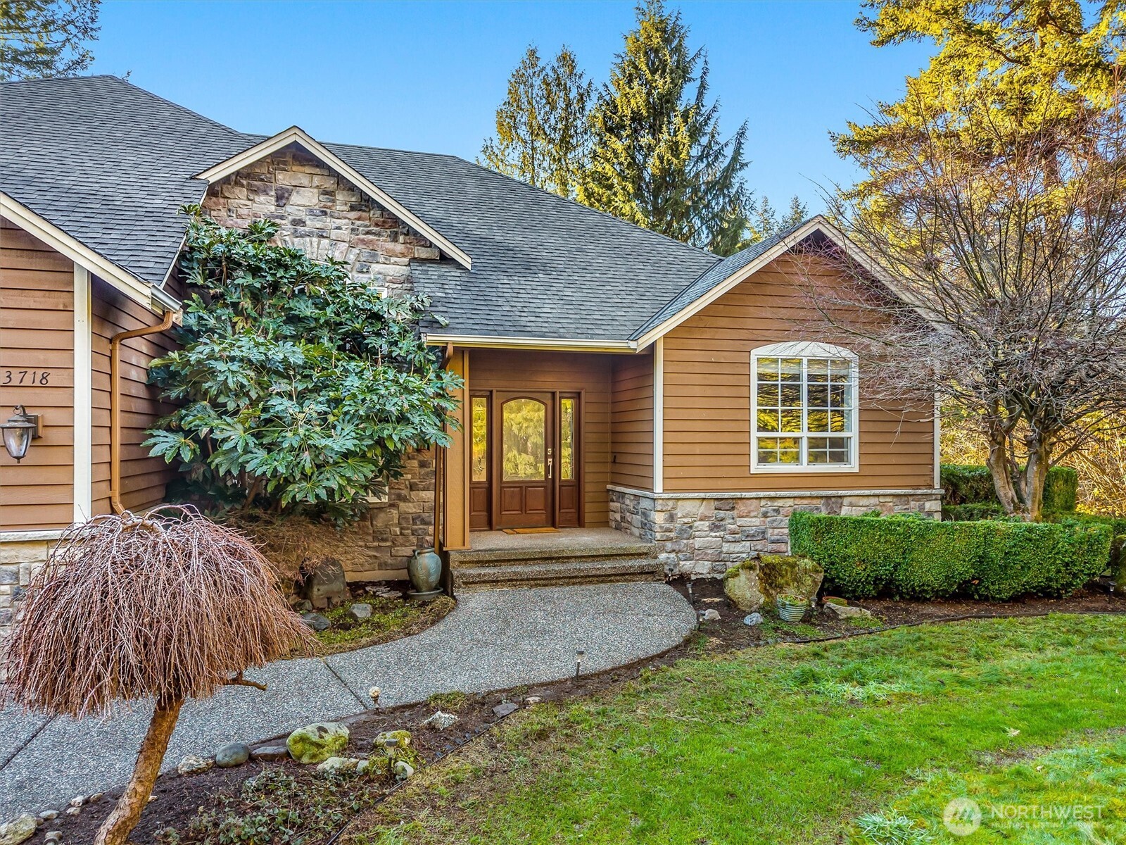 13718 58th Street Southeast Snohomish, WA 98290 - Photo 2 of 40 a front view of a house with garden