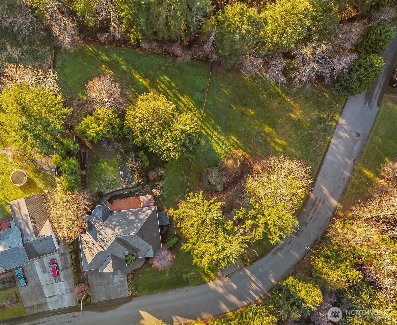 13718 58th Street Southeast Snohomish, WA 98290 - Photo 37 of 40 a view of a lake with a house in the background