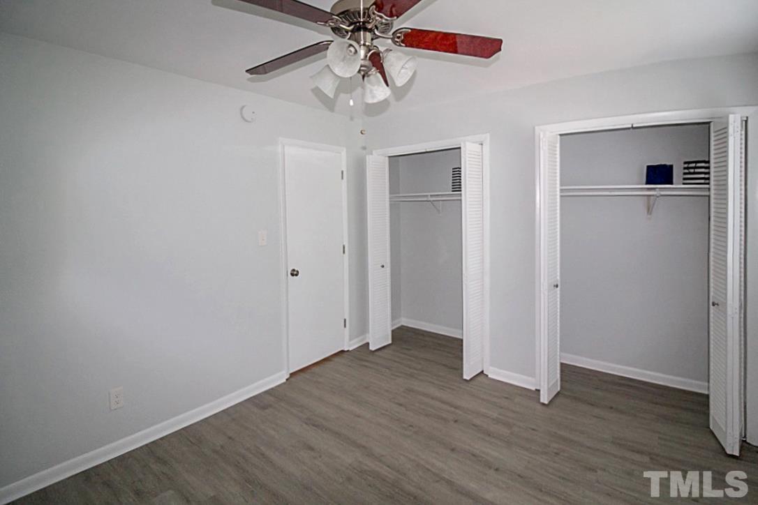 5840 Shady Grove Circle Raleigh, NC 27609 - Photo 11 of 18 an empty room with wooden floor closet and windows