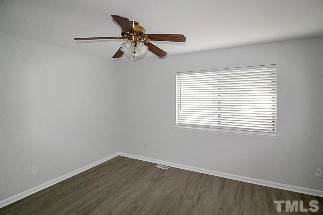 5840 Shady Grove Circle Raleigh, NC 27609 - Photo 12 of 18 a view of a room with wooden floor and windows