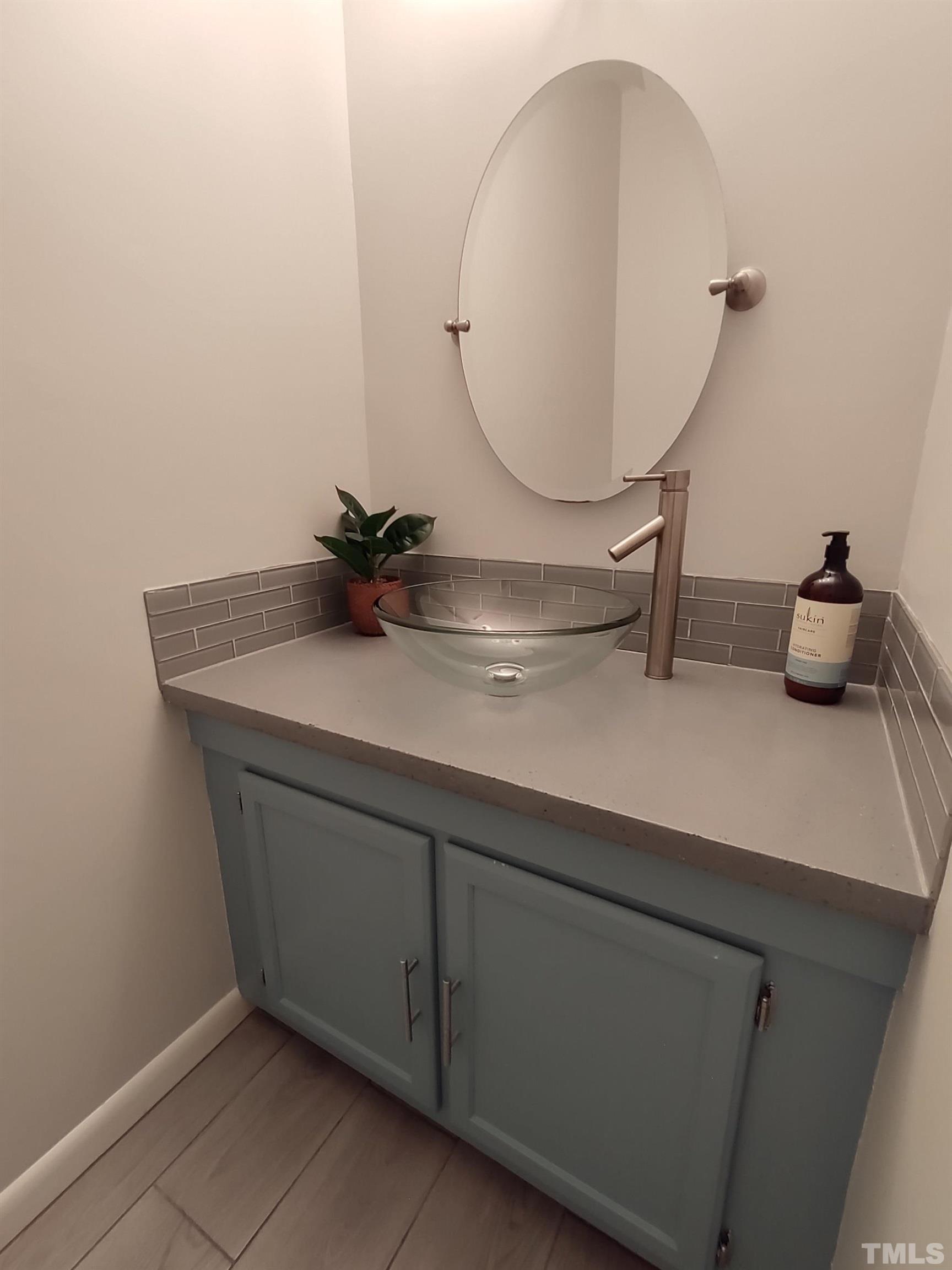 5840 Shady Grove Circle Raleigh, NC 27609 - Photo 14 of 18 a bathroom with a sink and a mirror
