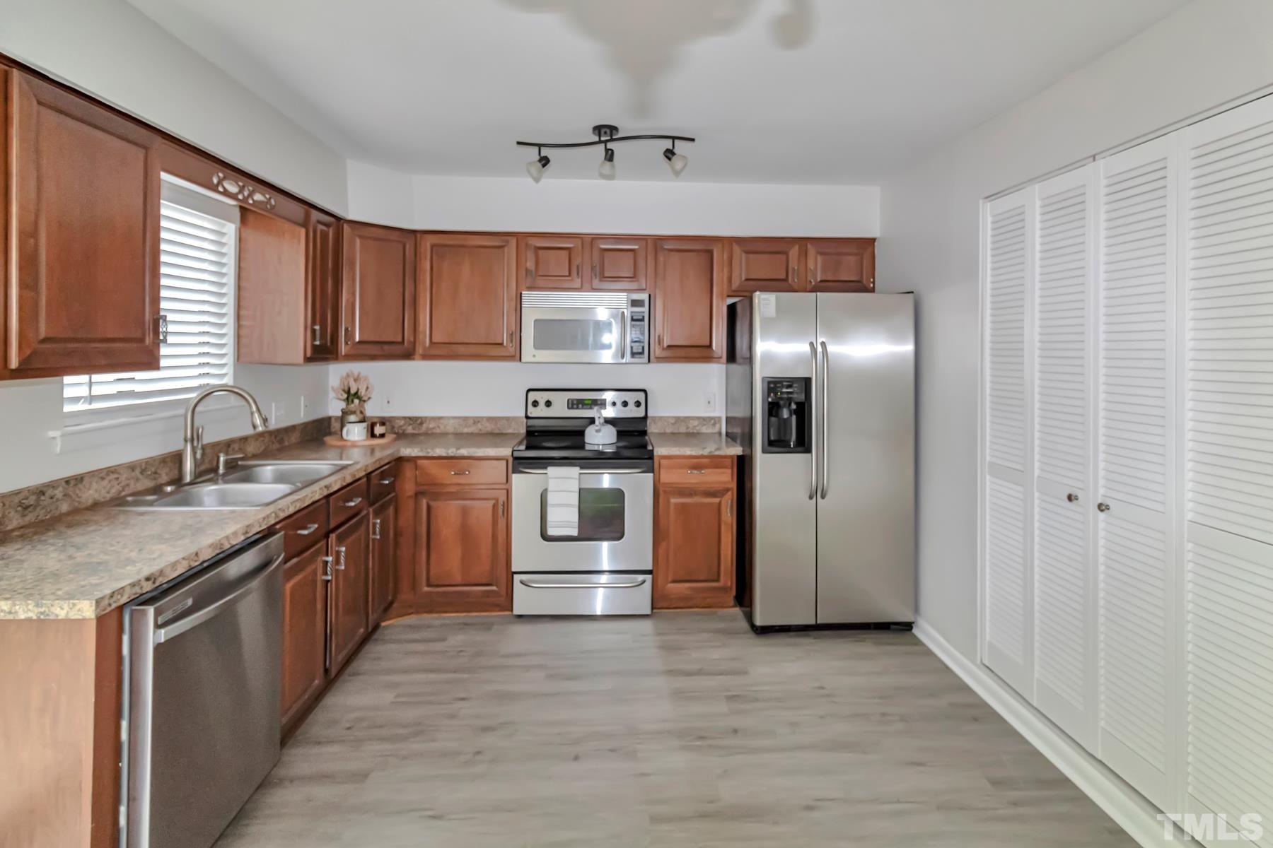 5840 Shady Grove Circle Raleigh, NC 27609 - Photo 4 of 18 a kitchen with granite countertop a refrigerator stove top oven and sink